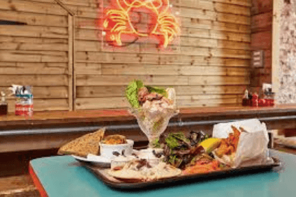 Where can visitors find a memorable seafood dining experience by the coast?